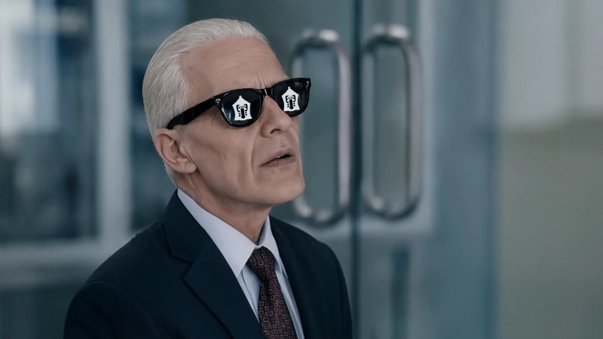 Manfred in a suit and dark glasses